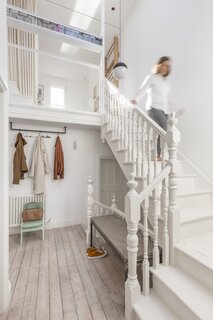 Architect Alessia Mosci and her partner bought this two-floor flat in a 1903 Edwardian building in London with the intention of fixing it up and reusing as many materials as possible. The stair volume was opened up to its full height, and the original stairs and floorboards kept and refinished.