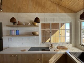 In the kitchen, minimalism prevails. Jared notes that the use of plywood was loosely inspired by design seen in the 1960s Sonoma County Sea Ranch community. "It's something that one of my heroes, [architect] Barbara Bestor has done very well," he says.