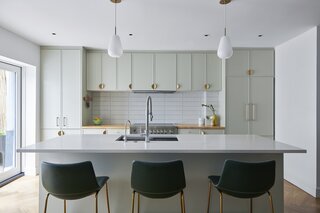 Lee helped the couple source lighting, like the Nuura Anoli pendants above the kitchen island. “We're constantly having meals at home,” says Serena. “We get a CSA and I like to cook, so it's nice to have a lot of space in the kitchen, and have it be really functional for cooking and entertaining.”