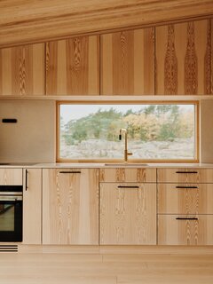The arrangement of windows in the home creates a play of light and shadow and allows the family to experience different views as they move around the space. “It’s about creating a calm, comfortable home that is still dynamic,” says architect Line Solgaard. “There are 360-degree views but you don’t see in every direction at all times—there are moments of drama throughout.”