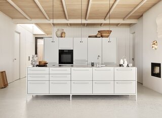 “We chose to have a very big kitchen,” says Egelund. “I love it when people cook together.” The kitchen is by Egelund’s brand Vipp, and is a design that was developed more than 14 years ago. The couple have the same kitchen in black in their Copenhagen apartment but decided that the warm gray color was better suited to the coastal setting of the summer house.
