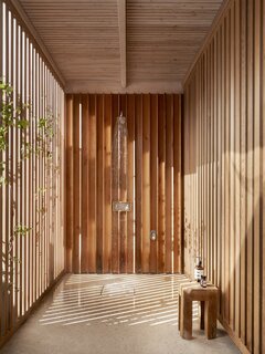 An outdoor shower set in the timber-clad walkway offers another way for the homeowners and their guests to connect with nature, and an easy way to rinse off after swimming.