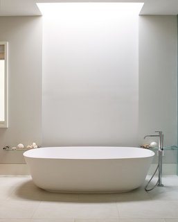 A freestanding Antonio Lupi tub defines the updated master bath, which also features an open-plan layout and a skylight by Velux.
