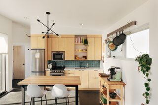 At 700 square feet, Chris and Ady's cottage had to make economical use of space—like the bar-height dining table doubling as a cooking countertop.