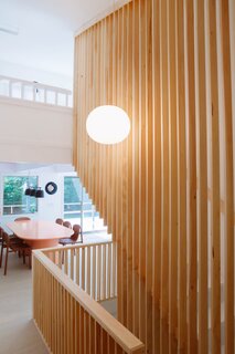 Now, floor to ceiling slats define the staircase. The pendant light is from Flos.