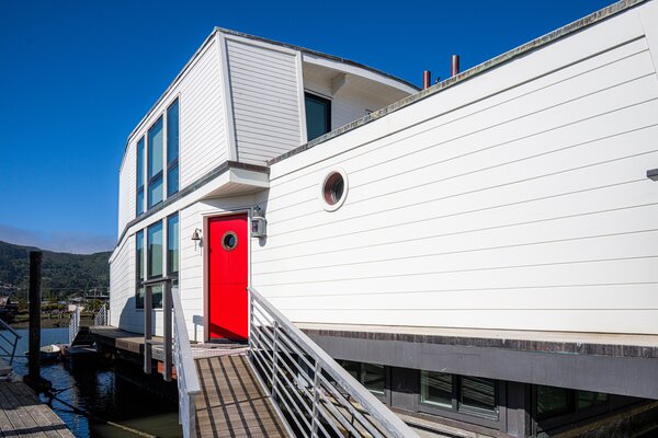 The 1,400-square-foot Seneca features white-painted wood cladding punctuated by a bright red front door with an original porthole.