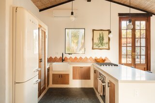 The kitchen cabinets were made with cabinet boxes set into framing, then a primed drywall shell covered with a textural Roman Clay finish, and sealed.