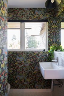 The powder room is wrapped in Josef Frank wallpaper.