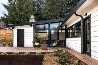 The private outdoor space showcases the renovation's south-facing windows, which were installed to connect the indoors with the yard.