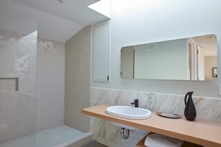 The upstairs guest suite includes a neutral, daylit bathroom.